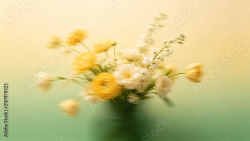 Dreamy Yellow Flower Bouquet with Soft Focus on Warm Pastel Green Background