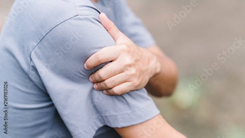 Cropped shot of a male gripping his sore upper arm muscle. Conceptualizing bicep strain, vaccination side effects, sudden workout injury, physical exhaustion, and muscular ache.