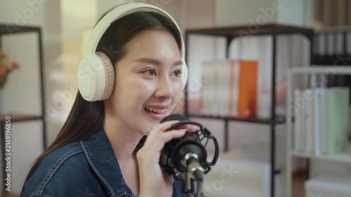 Podcast digital creator home studio microphone headphone voice recording woman shares heartfelt story with calm focus, warm smile, modern audio workflow in cozy room, engaging talk for online show