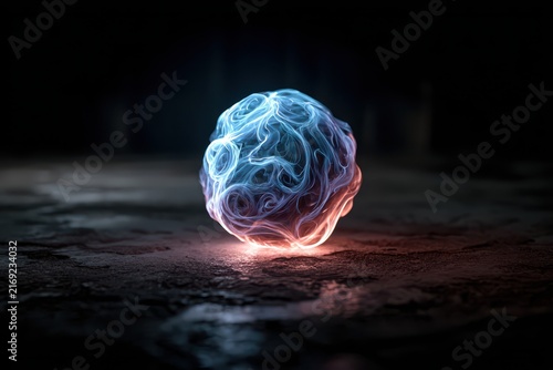 Glowing abstract orb with intricate patterns pulsating with energy in dark moody lighting against a textured ground