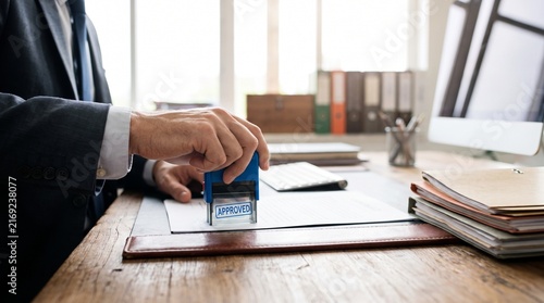 Professional businessman stamping approved on a contract in the office
