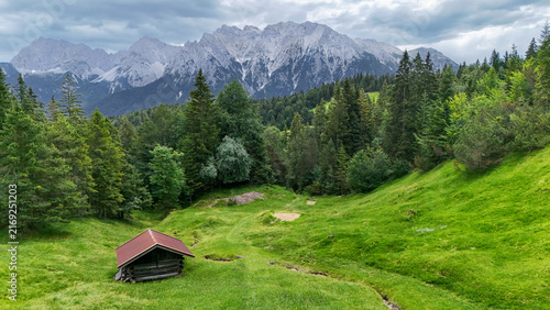 Fotografie Aerial drone view of beautiful summer landscape of green alpine meadow with trad