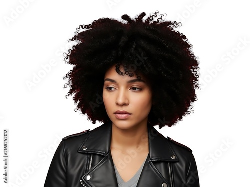 A portrait of a woman with voluminous afro hair wearing a leather jacket