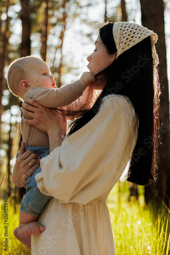Mother and baby bonding in a sunlit forest, gentle interaction