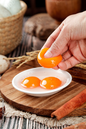 Fresh Egg Yolk Separation in Rustic Farmhouse Kitchen - Raw Cooking Ingredients on Wooden Board