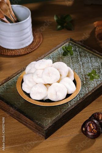 Traditional White Steamed Dumplings with Fresh Mint on Rustic Wooden Table