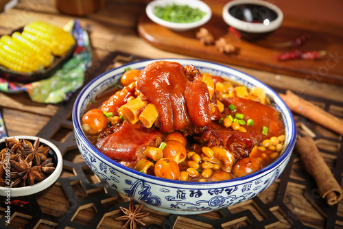 Chinese Braised Pig Trotters with Soybeans and Corn in Traditional Bowl