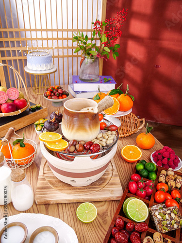 Cozy Winter Table with Fresh Fruits Nuts and Milk by Fireplace