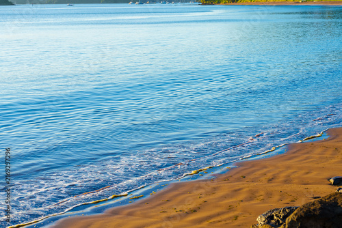 Idyllic calm blue water and golden sand at Te Ti Bay at Paihia