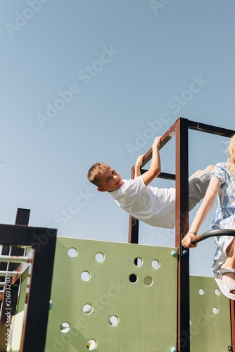 Happy Boy Playing on Modern Playground