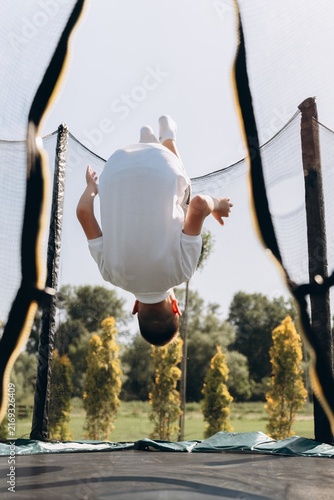 Happy Boy Enjoying Outdoor Trampoline Fun