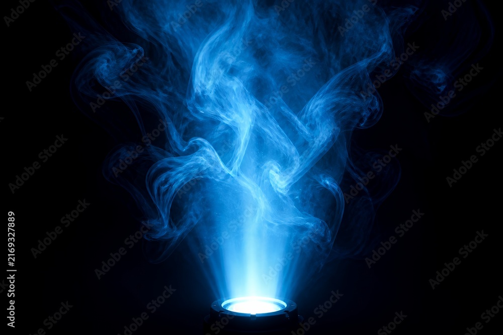 Obraz premium Blue smoke beam from spotlight, abstract light plume on dark background