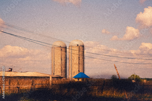 Cinematic vintage illustration of concrete silo towers on a rural farm