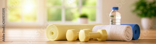 Active morning scene with exercise mat, lightweight training accessories, towel, water bottle and natural wooden flooring, sunlight through windows, realistic wellness lifestyle image