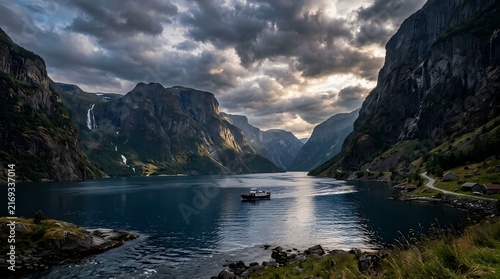 Stunning fjord scenery featuring towering cliffs and tranquil waters beneath a moody overcast sky