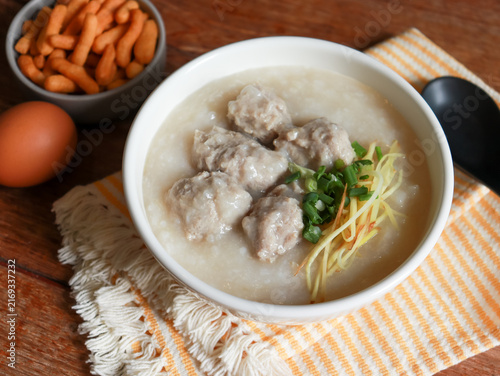 Congee or rice porridge top with minced pork, ginger and green onion. Popular breakfast bowl in China, Thailand, and Asia.