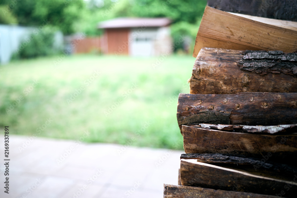 Naklejka premium Chopped firewood pile with rough cut surfaces