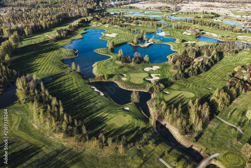 Obraz na plátně Golf course with multiple ponds and manicured grass