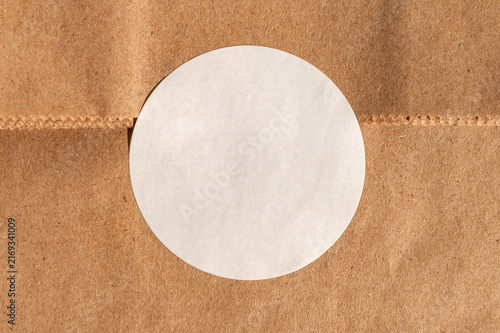 Blank white circle on brown kraft paper background texture
