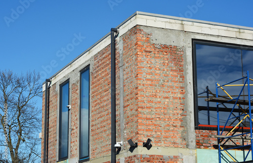 Flat roof drainage outlets on brick building outdoors