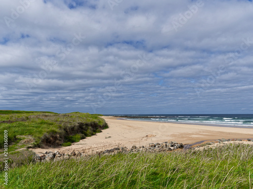 The wide and empty Sandy Beach at Charleston near to St Combs with the Marram grass covered dunes approaching the Foreshore.