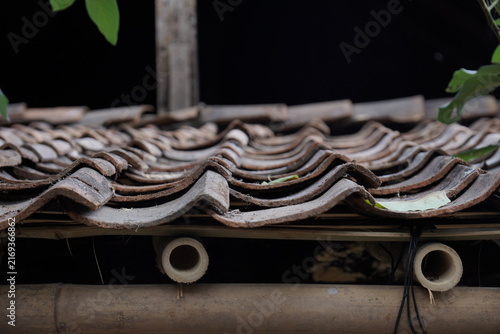 Traditional clay roof tiles on a bamboo structure for rustic architectural design