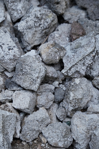 Grey granite rocks and crushed stone texture background for construction and landscaping design