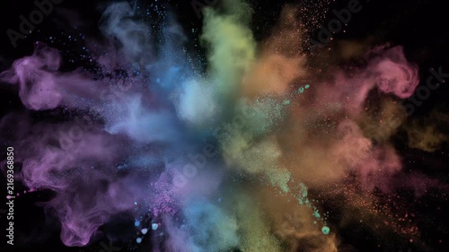 A vibrant explosion of multicolored powder bursts outwards against a stark black background.