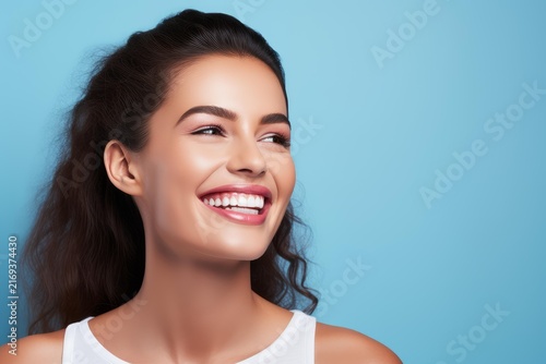 Happy young woman smiling, showing healthy teeth and radiant skin