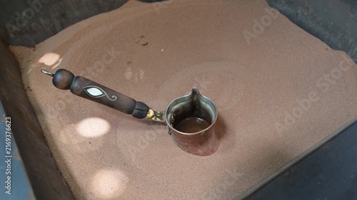 Marrakech, morocco. August 8, 2026. Traditional coffee preparation in a moroccan souk. A barista brews the aromatic beverage in a copper cezve heated by hot sand in marrakesh