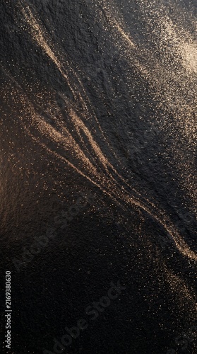 Vertical Obsidian Stone with Flowing Champagne Metallic Dust Abstract Background