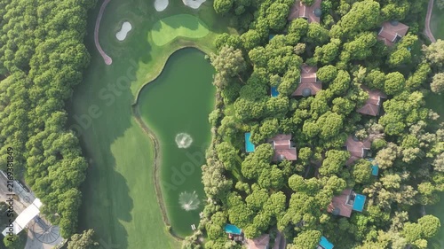 Aerial view of large mansion houses with swimming pool, in affluent neighborhood