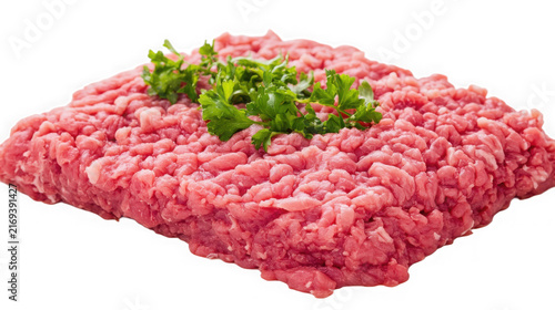 Fresh ground beef topped with green parsley isolated on a white background