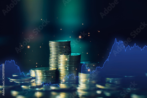 Obraz na plátně Coin stacks with blue market line chart illustrate investment analysis, financial trends, stock performance, economic data, trading strategy, wealth growth, and market volatility concepts