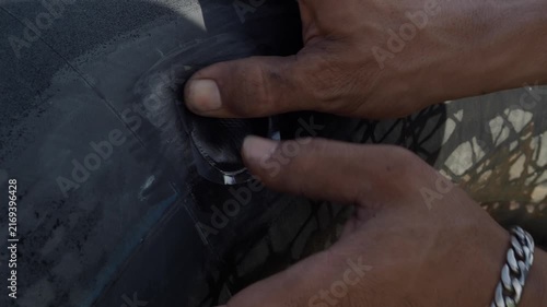 Cold patch tire repair involves applying a textured circular patch over the puncture site using adhesive and a plastic backing to repair a punctured tubeless tire.