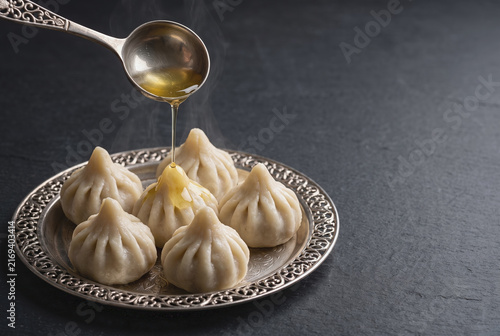 Steamed Modak Dumplings Drizzled with Ghee on Silver Plate