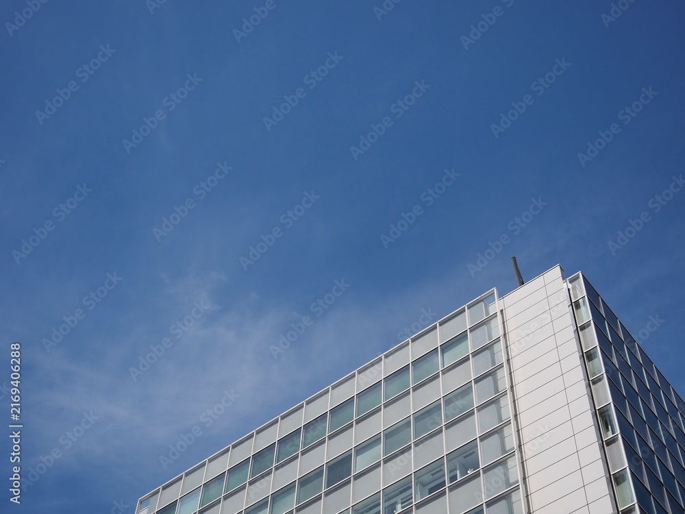 Fototapeta premium 青空の余白が広がる高層ビルの静かな都市風景