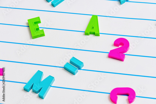 Canvastavla Colorful plastic magnetic letters and numbers on a white lined b