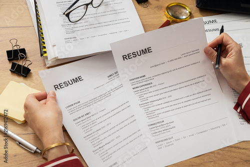 Human Resources Specialist Comparing Job Applicant Resumes