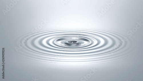 Concentric water ripples spreading across a clear surface from a drop.