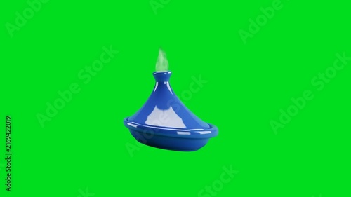 A shiny blue ceramic tagine pot with green steam on a bright green screen