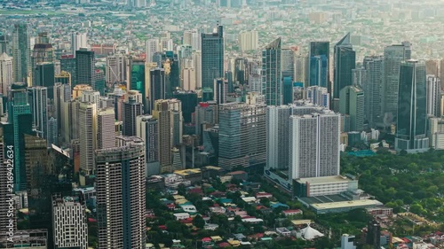 Aerial view of Makati central business district skyline with skyscrapers and residential areas during daytime in Manila Philippines.