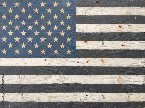 Distressed American flag pattern on rustic weathered wood texture background