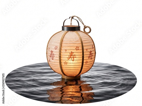 Glowing paper lantern floating on dark water surface for traditional Asian festival celebration