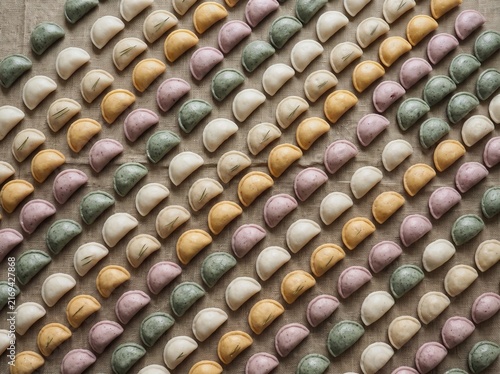 Colorful Songpyeon rice cakes arranged in a repeating pattern for Korean holiday food