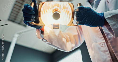 Obraz na płótnie POV, hands and dentist with light for dental procedure, extraction service or periodontal treatment