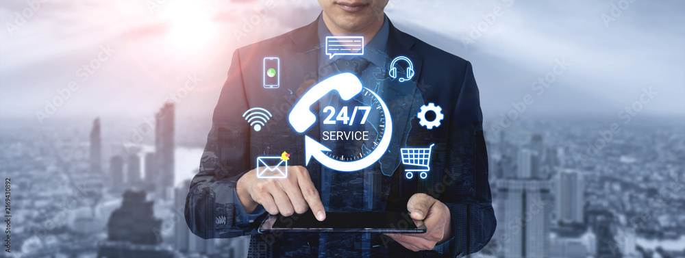 Obraz premium Business Professional Using Tablet to Access 24-7 Customer Service with Digital Icons in Cityscape Background Representing Modern Technology and Connectivity. Entropy.