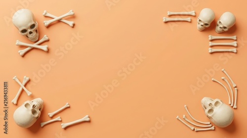 Human skulls and bones arranged in a decorative frame on a peach background