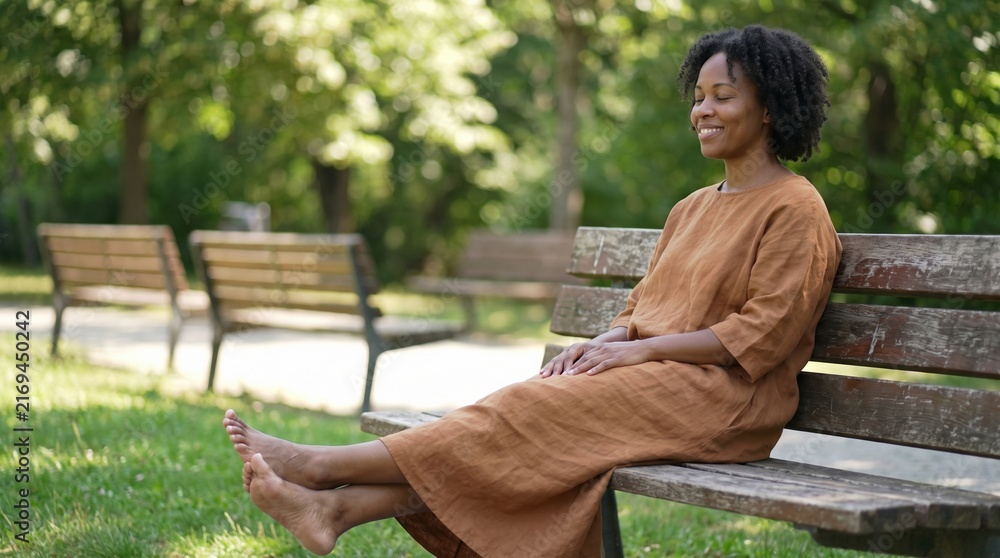 Fototapeta premium Woman sits on a wooden bench with closed eyes and bare feet. She practices grounding and forest bathing for mental reset. Ideal for wellness, therapy, and mental health content.