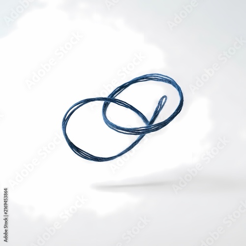Plakat Blue thread forming a geometric loop on a clean white background